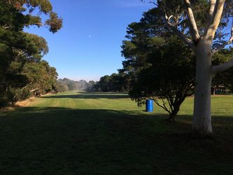 View from the 3rd tee with a large fairway ahead. The 12th tee is hidden in the trees to the right.